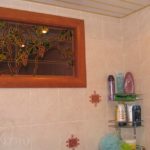 Как оформить окно между ванной и кухней
